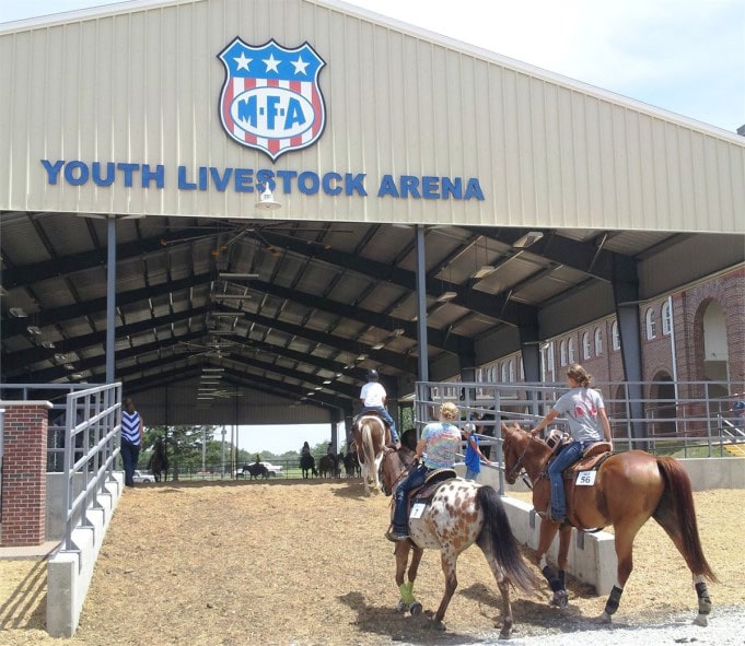 Girls riding horses into the MFA Youth Livestock Arena