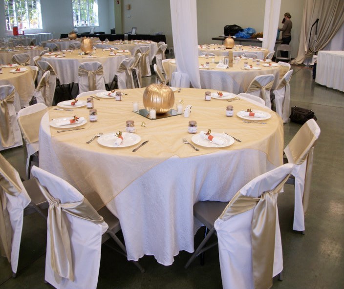 Round folding tables with folding chairs decorate for a wedding in the MEC building